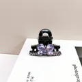 Elegant black hair claw clip with purple crystal butterfly design and sparkling gemstones - Violet