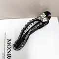 Detailed view of black resin hair claw clip with rhinestones and white floral accent - Claw Clip (3D Rhinestone Crystal)