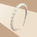 Detailed macro view of an elegant headband with densely set white pearls and a golden frame - White