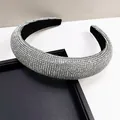 Detail of silver rhinestone padded headband on black textured tray showing clear sparkle - Padded High Top Style / White Zircon