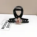 Detail of elegant black hair claw clip featuring champagne crystal floral petal ornaments - Medium Hair Claw / Rose Quartz