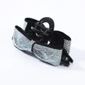 Macro detail of black bow hair claw clip featuring shimmering colorful rhinestones - AB Zircon