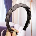 Détail d'un serre-tête en satin tressé gris foncé avec dents antidérapantes - Gris clair