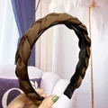 Detailed view of woven braid headband with non-slip teeth and glossy satin fabric - Coffee