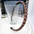 Detailed view of dark brown braided headband with non-slip teeth on inner band - Medium Coffee