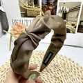 Detail van handgemaakte bronzen satijnen hoofdband met geplooide en gedraaide textuur - Licht koffiebruin