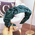 Elegant dark green satin twisted headband with pleated texture and handmade label - Peacock Green