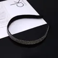 Detail of thin black headband encrusted with shimmering silver rhinestones on display - Transparent Gray Rhinestone Style