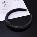 Macro shot of black sponge headband with glittering rhinestones and elegant reflection - Black