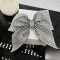 Macro view of crystal bow hair clip with colorful rhinestones on a display stand - Large Pointed Swallowtail Spring Clip (A-9-3-8) / AB Zircon
