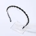 Elegant braided rhinestone headband with black beads on a minimalist display stand - Black Zirconia