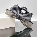 Close-up of elegant black satin ribbon hair claw clip with shimmering silver rhinestones - Grey Rhinestone