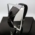 Detailed close-up of black satin headband featuring a large colorful rhinestone bow - Black Satin Bow Headband with AB Rhinestones