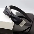Close-up of elegant black satin headband with a sparkling rhinestone-embellished bow - Black Satin Bow Headband with White Rhinestones