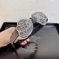 Close-up of sparkling rhinestone bow headband with high-gloss AB crystals detail - Clear Gray Full Rhinestone Bow