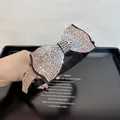 Detail of elegant oversized bow headband with shimmering pink and AB crystals on velvet - Champagne Rhinestone