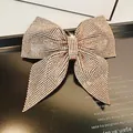 Champagne gold bow hair clip with luxury full rhinestone inlay on black background - Large Pointed Swallowtail Spring Clip (A-9-3-8) / Champagne Rhinestone