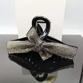 Elegant black hair claw clip featuring a large bow fully paved with sparkling rhinestones - Transparent Grey Rhinestone