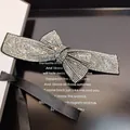 Sparkling rhinestone bow hair clip with black ribbon on elegant gift box package - Transparent Grey Rhinestone