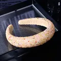 Close-up of elegant wide headband featuring dense colorful crystal beads and soft lining - Colorful