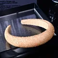 Macro view of champagne gold hand-beaded headband with thick sponge padding and texture - Champagne