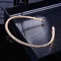 Close-up of rose gold rhinestone headband with sparkling crystals on black display tray - Champagne Rhinestone