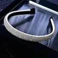 Detailed close-up showing luxury silver-white rhinestones on a slim headband accessory - White