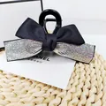 Detail of French vintage bow hair claw clip with colorful rhinestones on black satin fabric - AB Zircon
