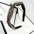 Macro detail of sparkly rhinestone headband with elegant knotted design and silver crystals - Transparent Grey Rhinestone