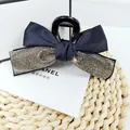 Detail of elegant black ribbon hair claw clip featuring shimmering silver rhinestone trim - Transparent Grey Rhinestone
