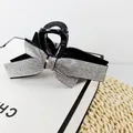 Elegant black bow hair claw clip with silver rhinestones on a minimalist gift box - White Zircon