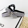 Elegant black claw clip with a large sparkling rhinestone bow for luxury hair styling - AB Zircon