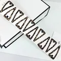 Detailed view of ten triangular leopard print BB hair clips on a white display card - Leopard Triangle Style