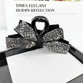 Elegant large shark hair claw with silver rhinestones on a black bow-shaped resin clip - Gunmetal Black Rhinestone
