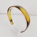 Detail view of amber gradient headband with non-slip teeth on a clear display stand - 2.5cm Wide Edge / Coffee