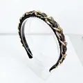 Close-up of luxury baroque headband featuring gold metal chains and black crystal beads - Gunmetal