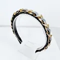 Close-up of golden metal chains and iridescent rhinestones on a baroque headband - AB Zircon