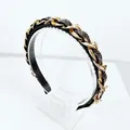 Close-up of baroque headband with gold chains and dark gray rhinestones on black fabric - Transparent Grey Rhinestone