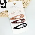Close-up of four teardrop hair clips in earth tones on a branded white paper card - Earth Tone Water Drop Style (NM-6621)
