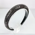 Detailed view of luxury wide headband with shimmering black rhinestones on clear stand - 2.5cm High Top / Gunmetal Black Rhinestone