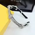 Detail of elegant silver rhinestone headband featuring four decorative twisted knots - White Zircon