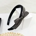 Detail of elegant black sponge headband featuring a large bow with silver rhinestones - Transparent Grey Rhinestone
