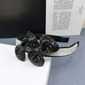 Macro detail of luxury double bow headband with shimmering black and silver rhinestones - Black Zircon