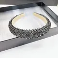 Close-up of sparkling black faceted crystal beads on a padded headband with fabric lining - Gunmetal Black Rhinestone Style