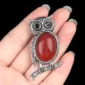 Silver owl necklace with large red natural stone and black rhinestone eyes on black background - Red Agate