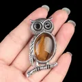 Silver owl necklace pendant featuring a polished oval tiger eye stone and black gem eyes - Tiger's Eye