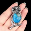 Silver owl necklace featuring an oval blue striped natural agate stone and black eyes - Blue Agate
