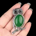 Vintage silver owl necklace with green gemstone inlay held against a black background - Green Malaysian Jade (Optimized)