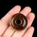 Natural tiger eye stone donut bead with polished finish and golden-brown chatoyancy - Tiger's Eye