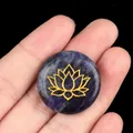 Polished dark purple crystal stone with golden lotus engraving for meditation and yoga - Blue Sodalite